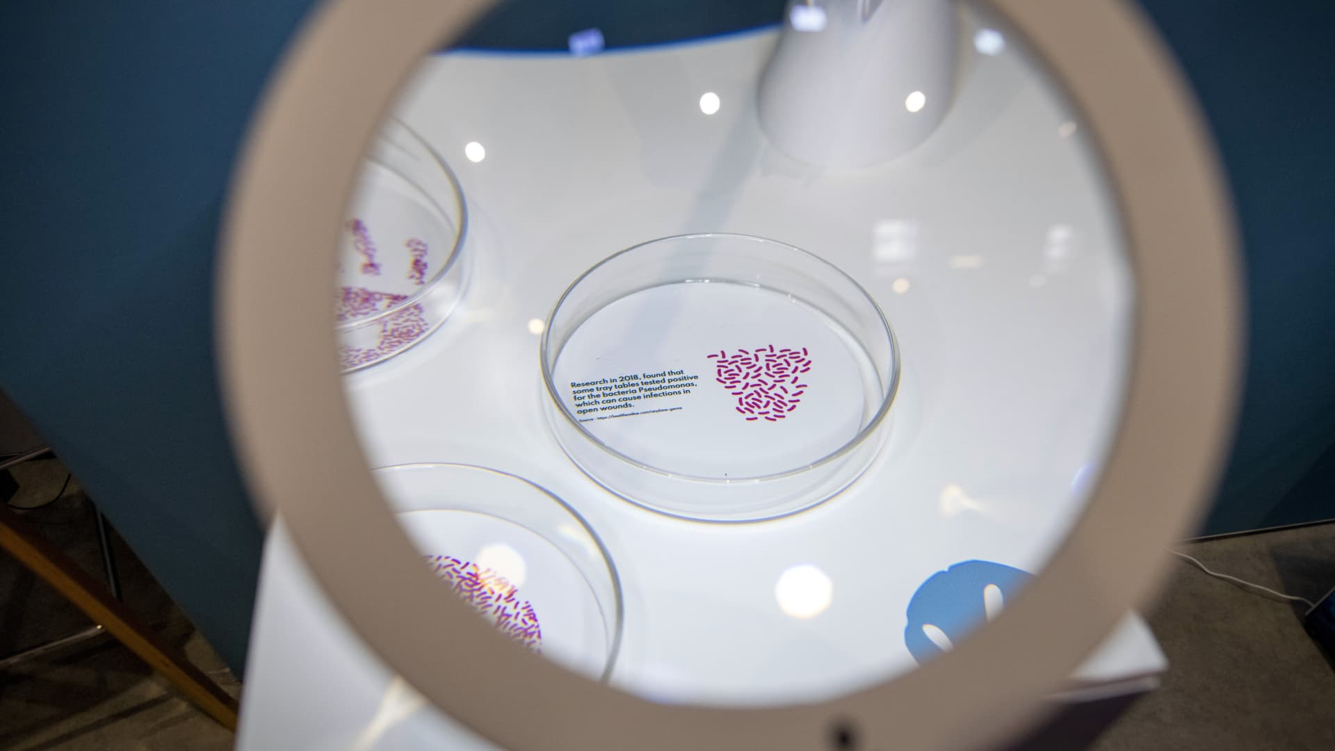 A petri dish remarking on the bacterial contamination of tray tables at the booth for Polygiene AB, which offers antimicrobial, antibacterial and anti odor technology, at the Aircraft Interiors Expo in Hamburg, Germany, on Wednesday, June 15, 2022.
