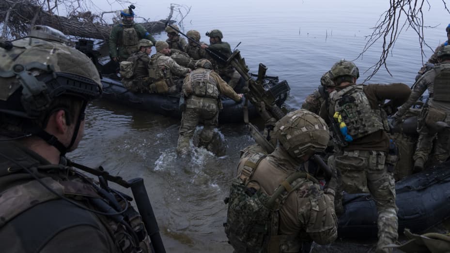 Militares ucranianos abordan un barco en la orilla del río Dniéper en la línea del frente cerca de Kherson, Ucrania, el 15 de octubre de 2023.