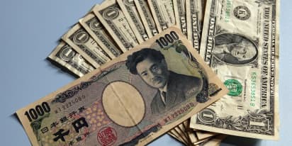 Yen surges after BOJ hints at policy shift, sending dollar lower 