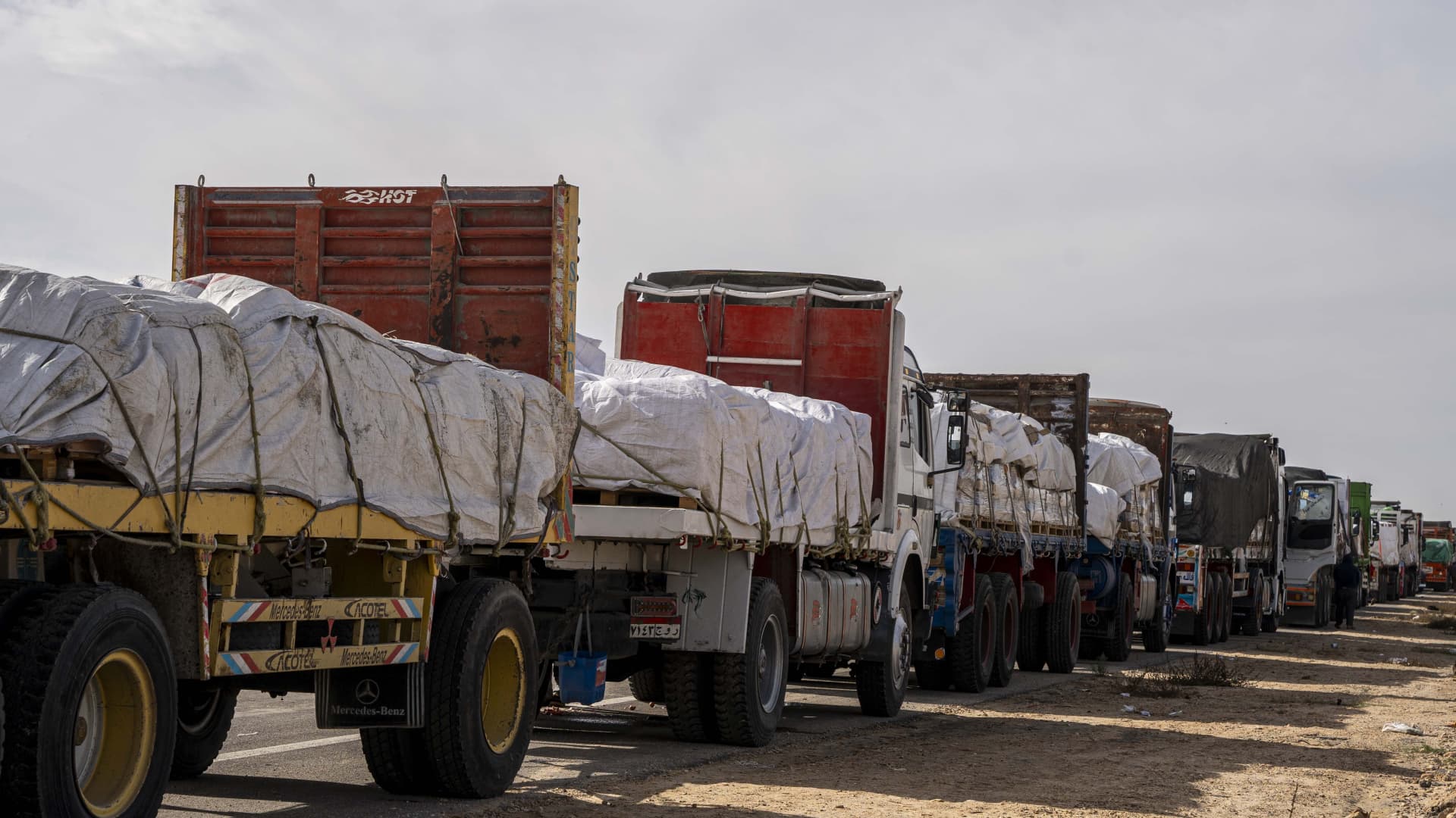 Trucks carrying aid await an opportunity to enter Gaza via the Rafah crossing on November 22, 2023 in Arish, Egypt. 