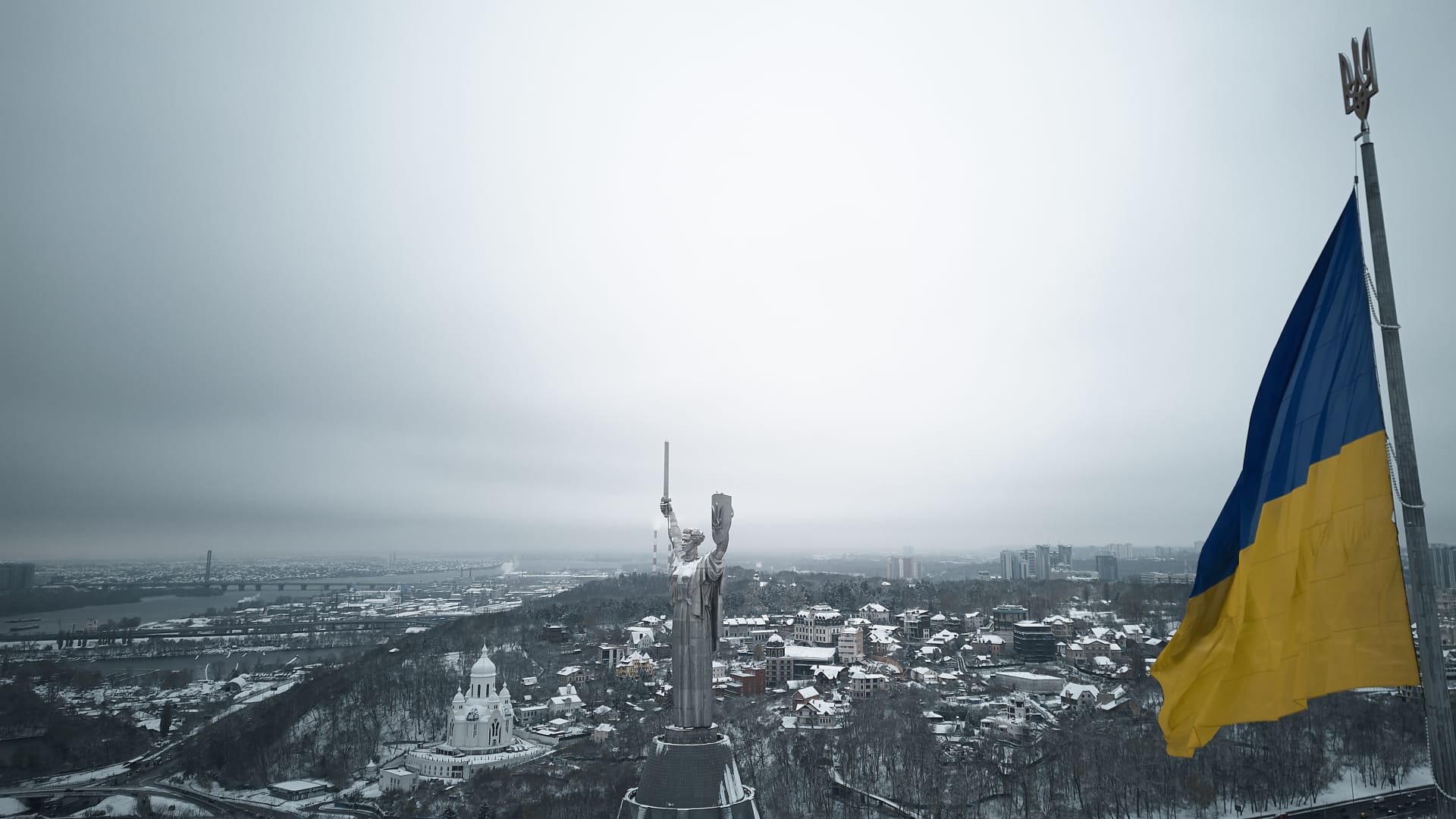 An aerial view shows Ukraine's Motherland monument, with its new Ukrainian coat of arms shield, after fresh snowfall on November 22, 2023 in Kyiv, Ukraine.