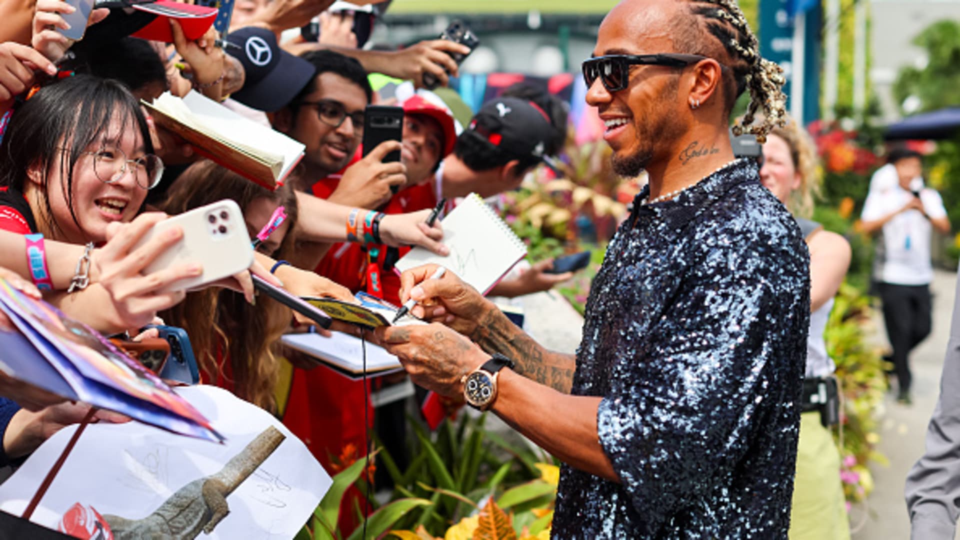 Lewis Hamilton interacts with fans outside the paddock during Singapore's F1 Grand Prix on Sept. 17, 2023.