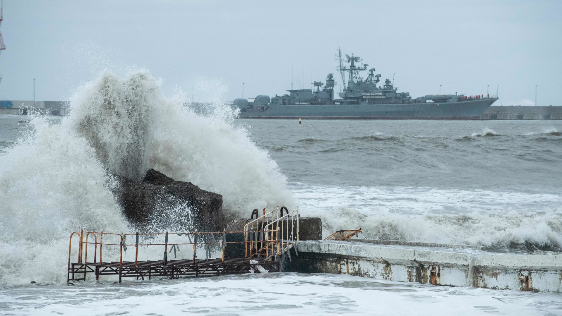 A warship is seen docked in the port of the Black Sea resort city of Sochi during a storm on November 27, 2023.