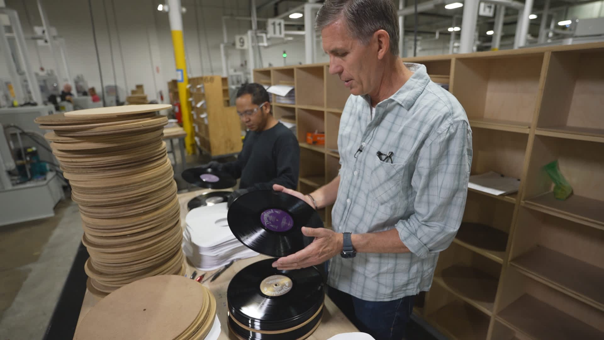 United Record Pressing CEO Mark Michaels inspecting a vinyl record.