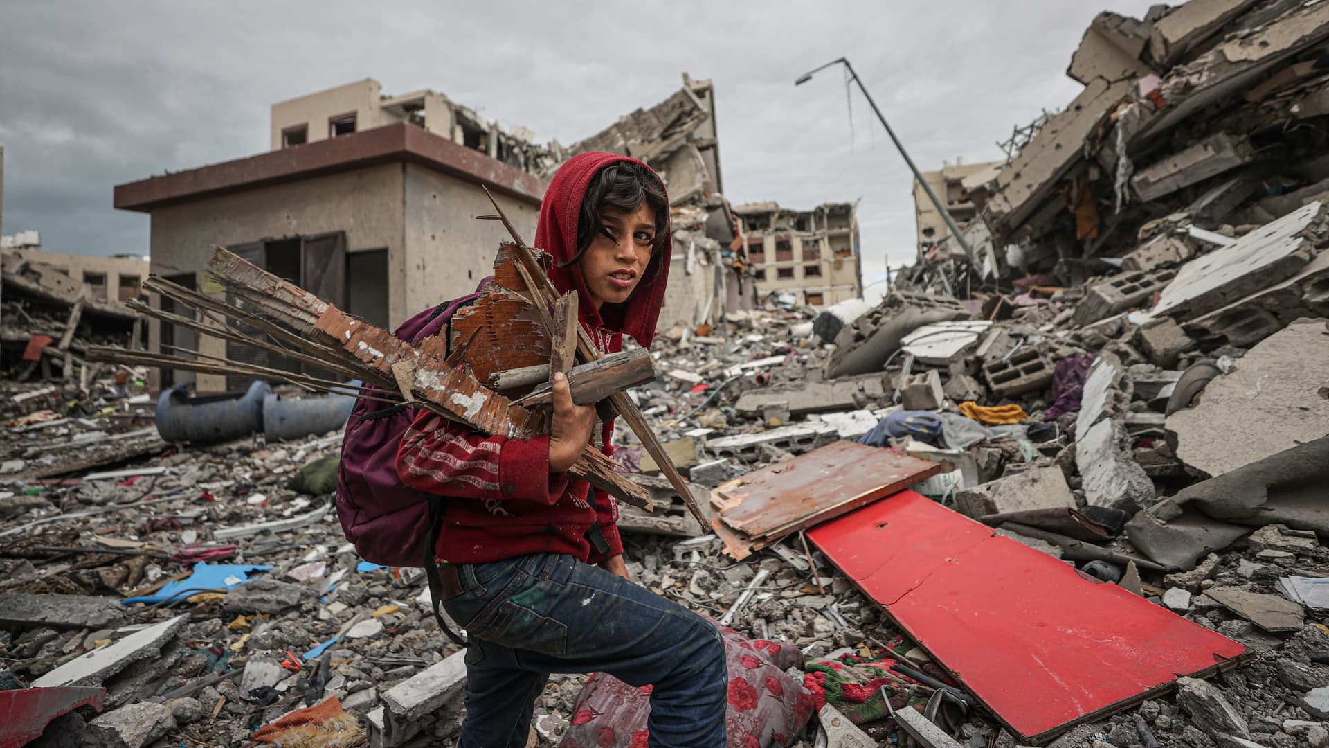 A child walks among the rubble in the residential area known as Juhor ad-Dik, built by the Turkish Cooperation and Coordination Agency (TIKA) and heavily damaged due to Israeli attacks in the southeastern part of the enclave of Gaza Strip on November 28, 2023. 