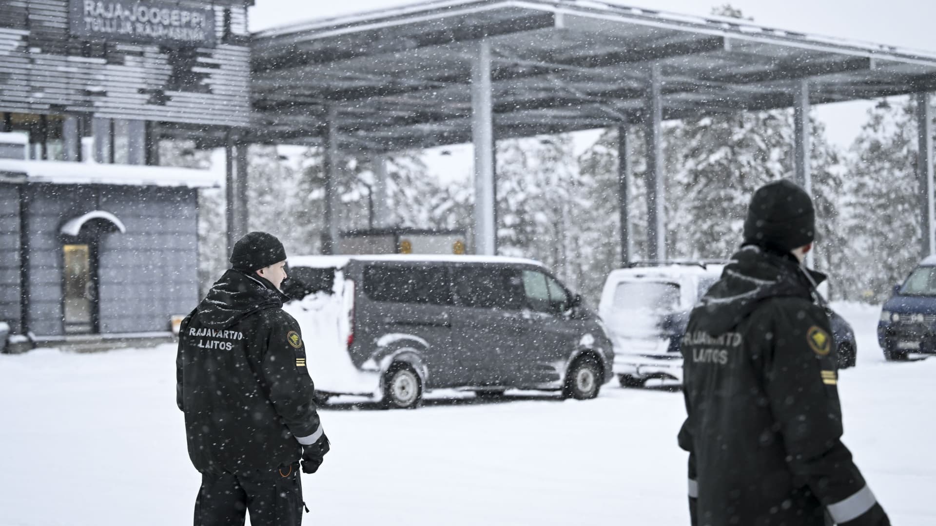 Finnish border guard officers walk in the snow at the Raja-Jooseppi border crossing station to Russia in Inari, northern Finland, on November 25, 2023. Raja-Jooseppi in the far north of Finnish Lapland is the only crossing point open on the country's eastern border. Finland has closed seven checkpoints in response to Russian officials allowing increasing numbers of undocumented asylum seekers to pass through to the Finnish side of the border. (Photo by Emmi Korhonen / Lehtikuva / AFP) / Finland OUT (Photo by EMMI KORHONEN/Lehtikuva/AFP via Getty Images)