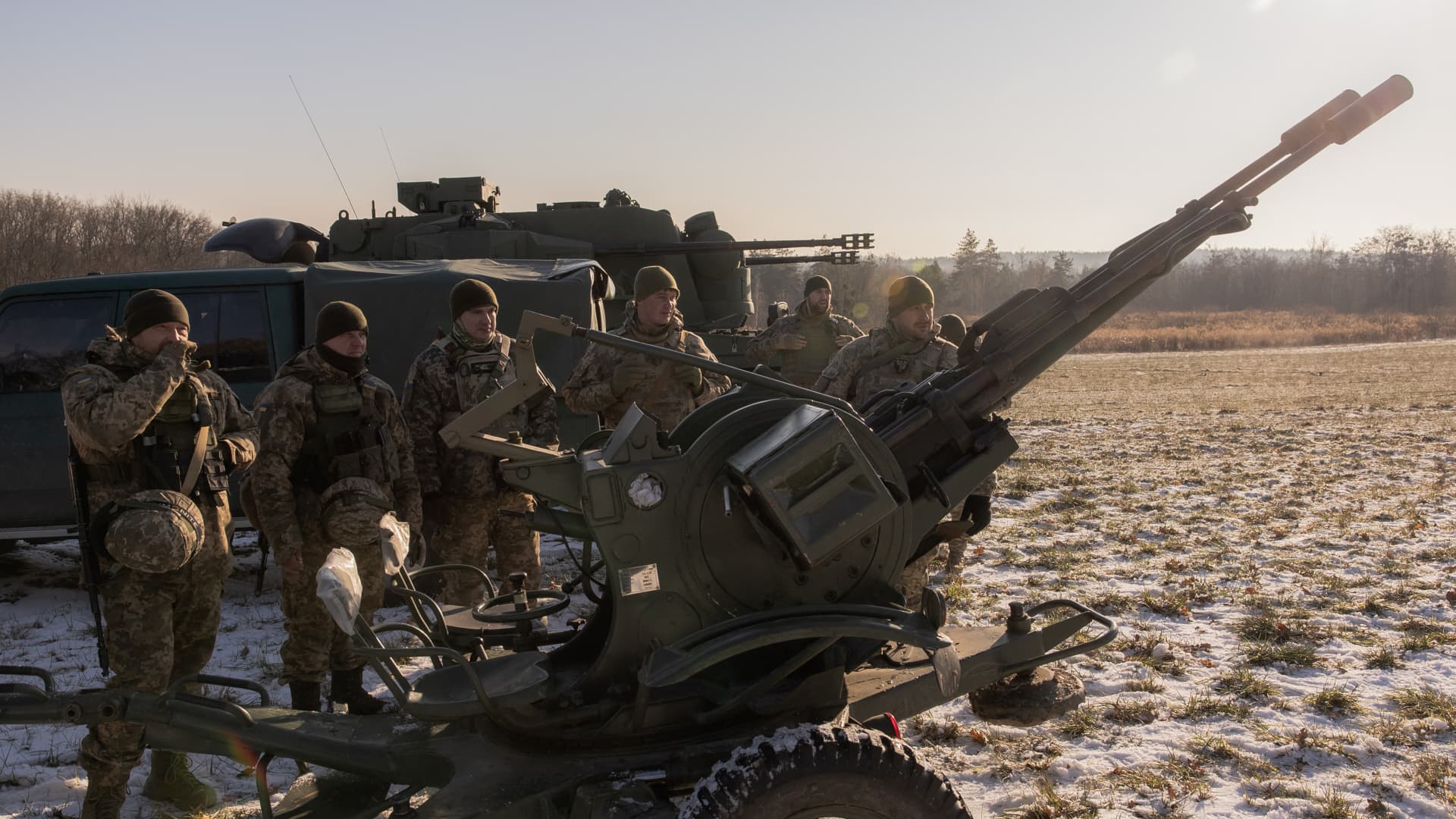 Ukrainian servicemen of a drone hunting team stand next to an anti-aircraft twin-barreled autocannon that they use to target Russian launched drones, in the outskirts of Kyiv, on November 30, 2023, amid the Russian invasion of Ukraine. 