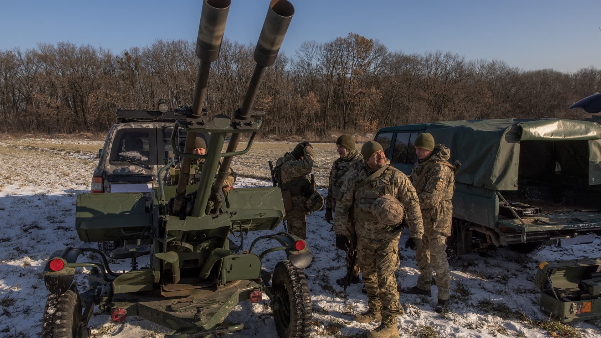 Ukrainian servicemen of a drone hunting team stand next to an anti-aircraft twin-barreled autocannon that they use to target Russian launched drones, in the outskirts of Kyiv, on November 30, 2023, amid the Russian invasion of Ukraine.