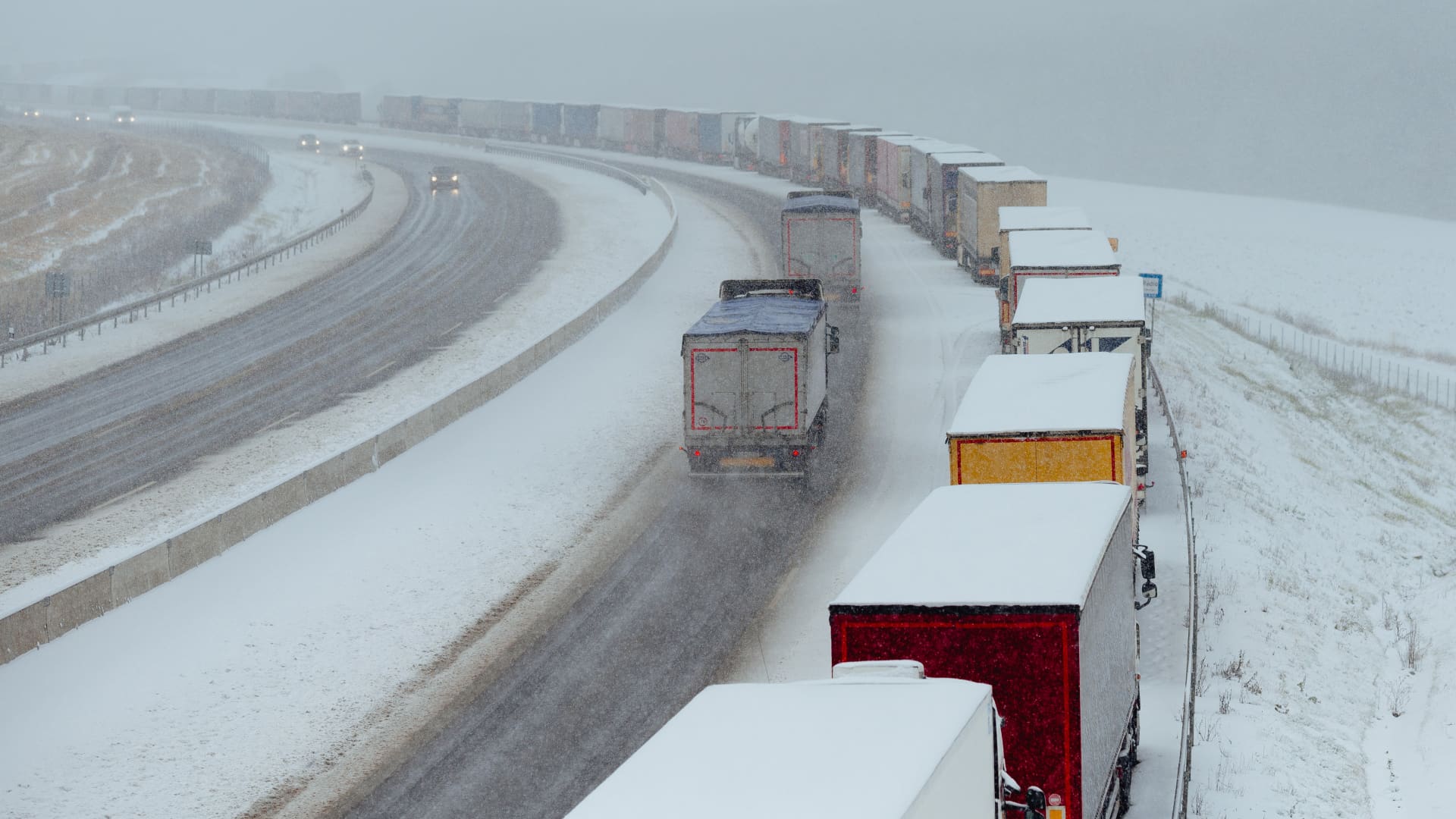 Snow-covered trucks stand in a long, over 7km long queue near Bidovce, Slovakia on November 28, 2023. 