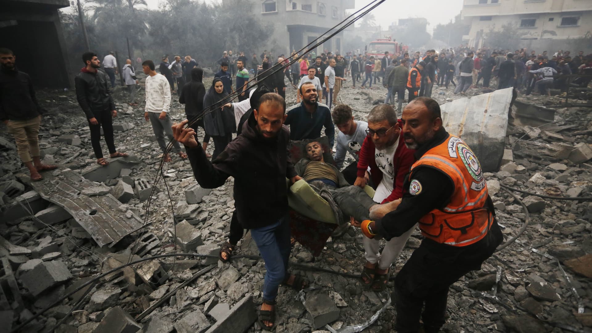 An injured person is pulled out among the rubble as civil defense team and residents extinguish the fire and conduct a search and rescue operation among the rubbles of the buildings following an Israeli attack in Deir al-Balah, Gaza on December 05, 2023. (Photo by Ashraf Amra/Anadolu via Getty Images)