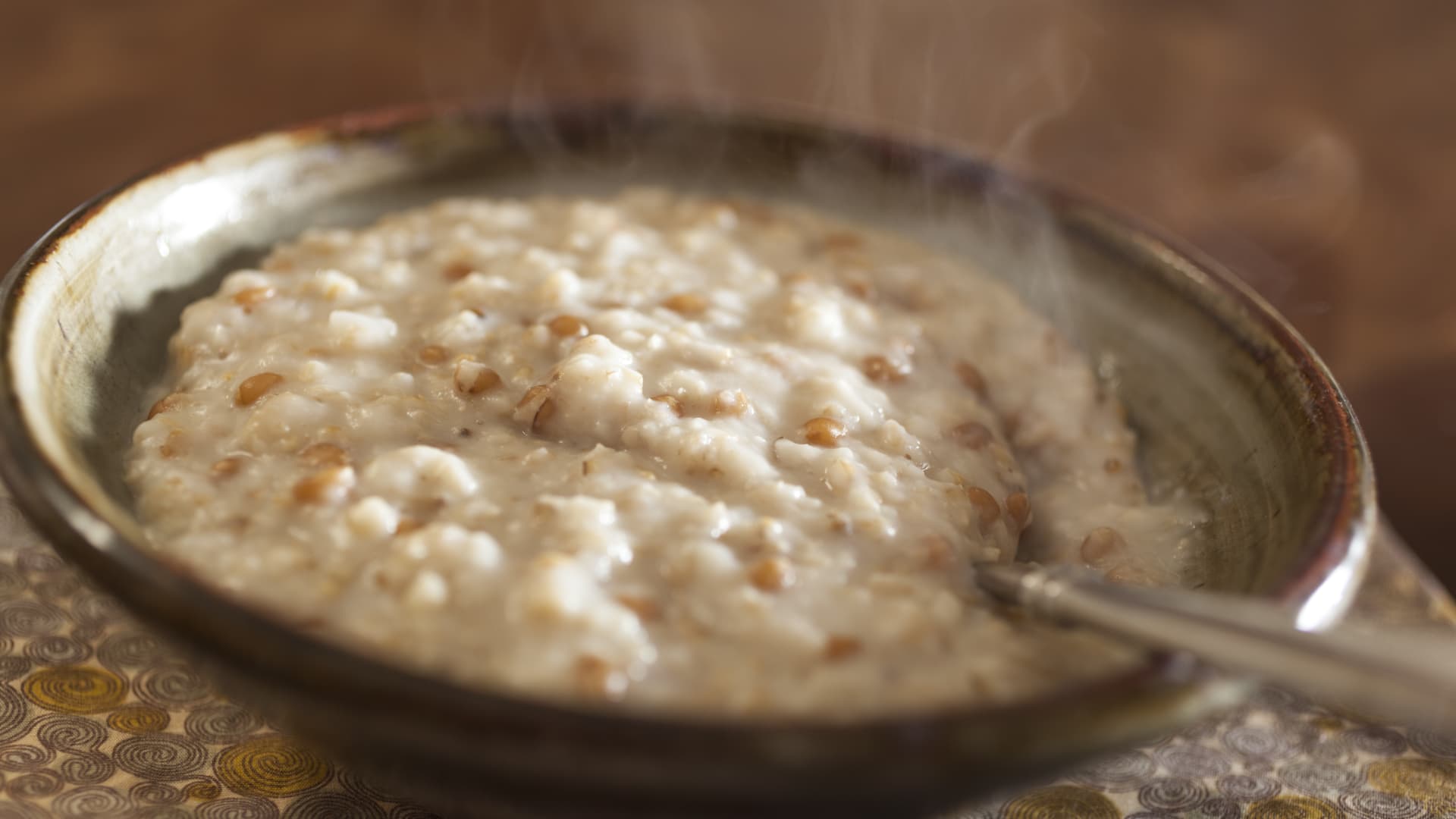 Steaming bowl of oatmeal porridge, made with Irish oats, wheat berries and barley.
