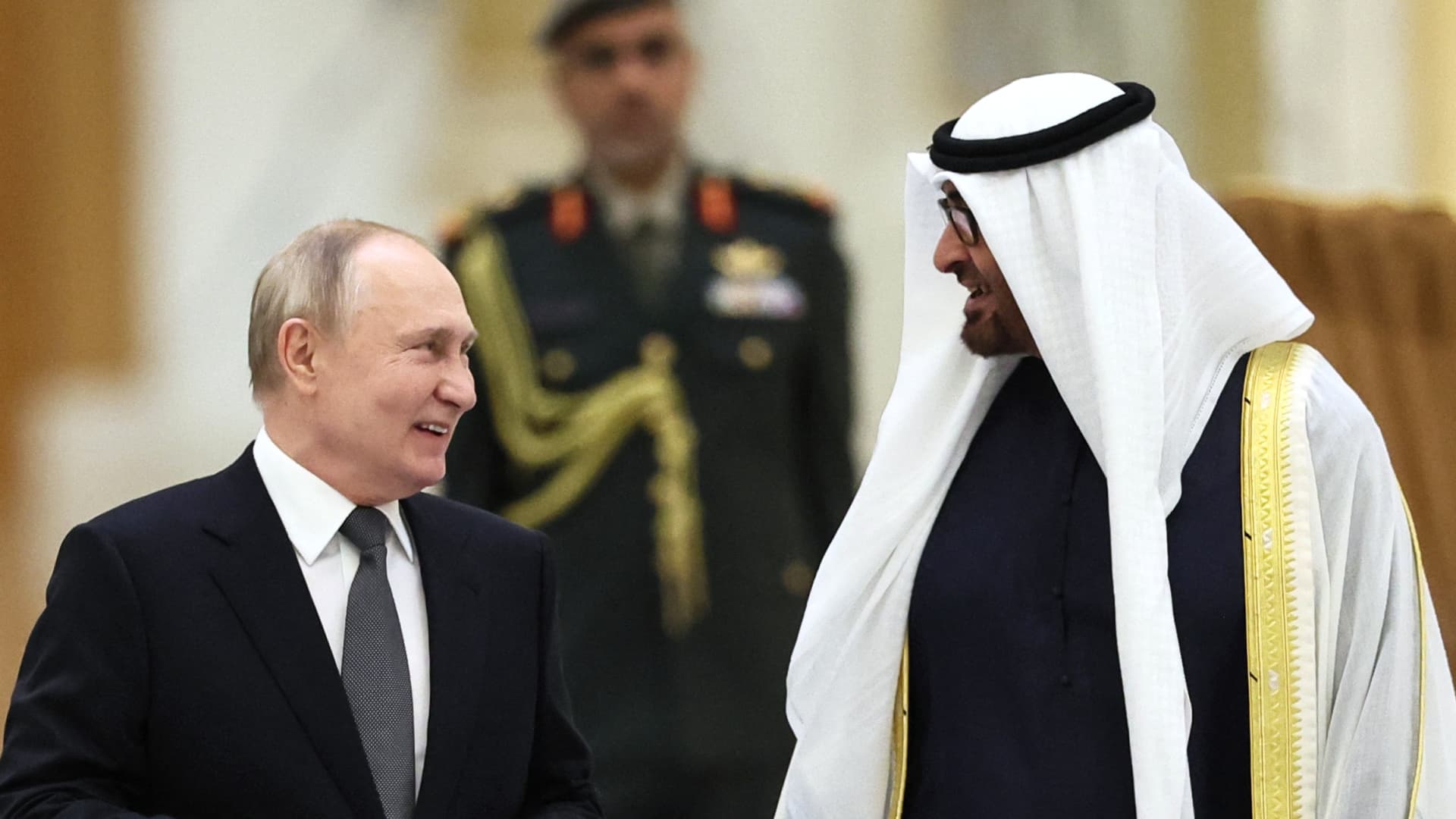 This pool photograph distributed by Russian state agency Sputnik shows Russia's President Vladimir Putin and President of the United Arab Emirates Sheikh Mohamed bin Zayed Al Nahyan attending a welcoming ceremony ahead of their talks in Abu Dhabi on December 6, 2023. 