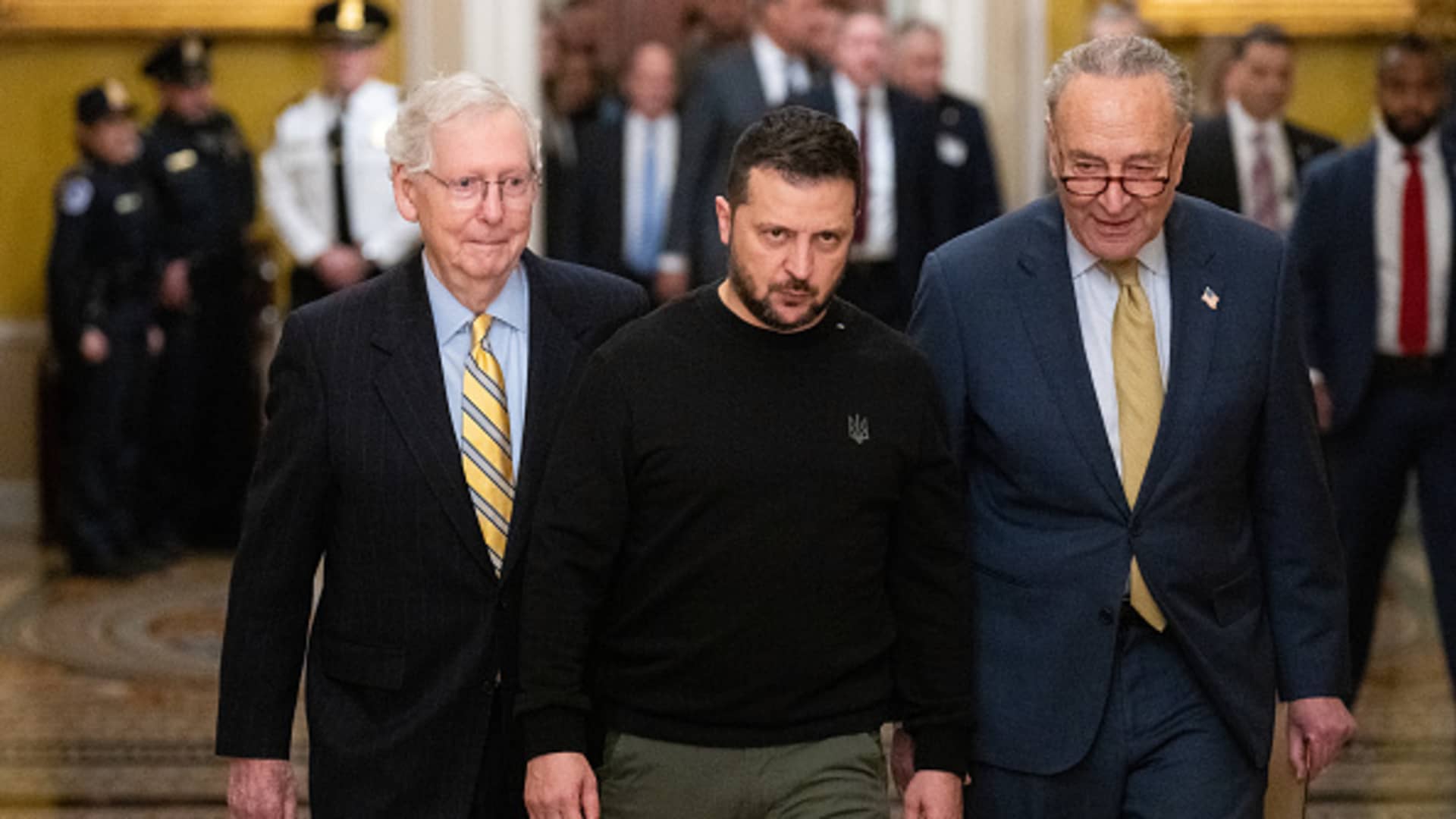 Ukrainian President Volodymyr Zelenskyy, center, is escorted by Senate Minority Leader Mitch McConnell, R-Ky., left, and Senate Majority Leader Chuck Schumer, D-N.Y., to his meeting on military aid with U.S. Senators in the U.S. Capitol on Tuesday, December 12, 2023.