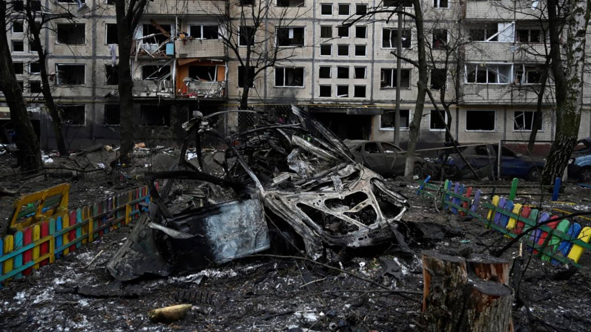 This photograph taken on December 13, 2023 shows a destroyed car next to a damaged residential building following a missile strike in Kyiv, amid the Russian invasion of Ukraine. (Photo by SERGEI CHUZAVKOV / AFP) (Photo by SERGEI CHUZAVKOV/AFP via Getty Images)