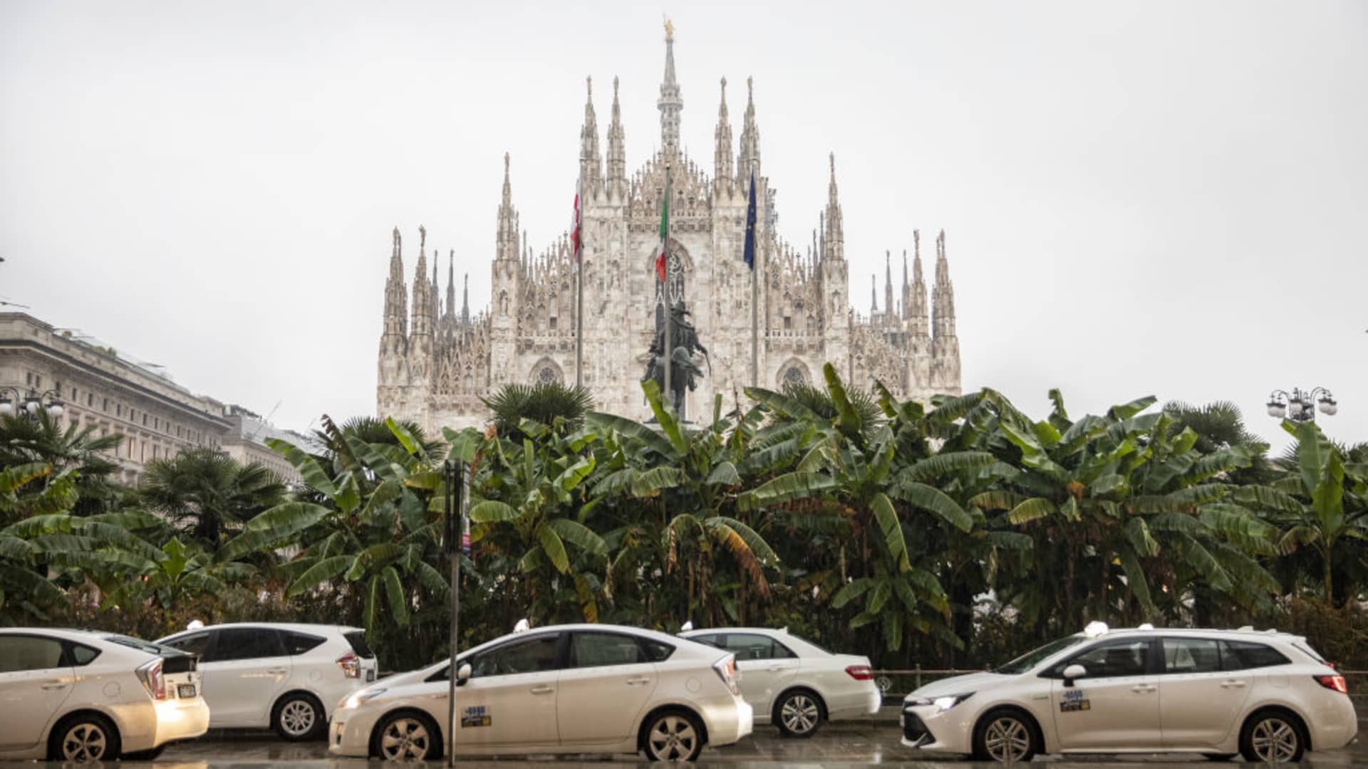 Taxis parked in front of the Duomo Cathedral in Milan, Italy.