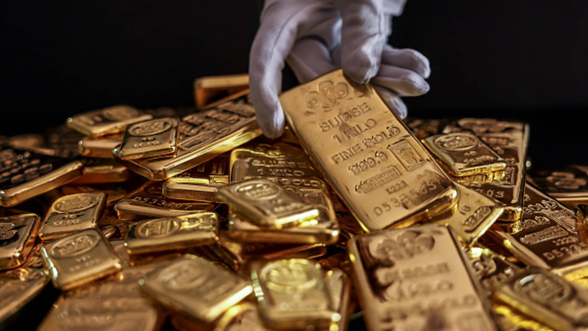 An employee handles one kilogram gold bullions at the YLG Bullion International Co. headquarters in Bangkok, Thailand, on Friday, Dec. 22, 2023. 