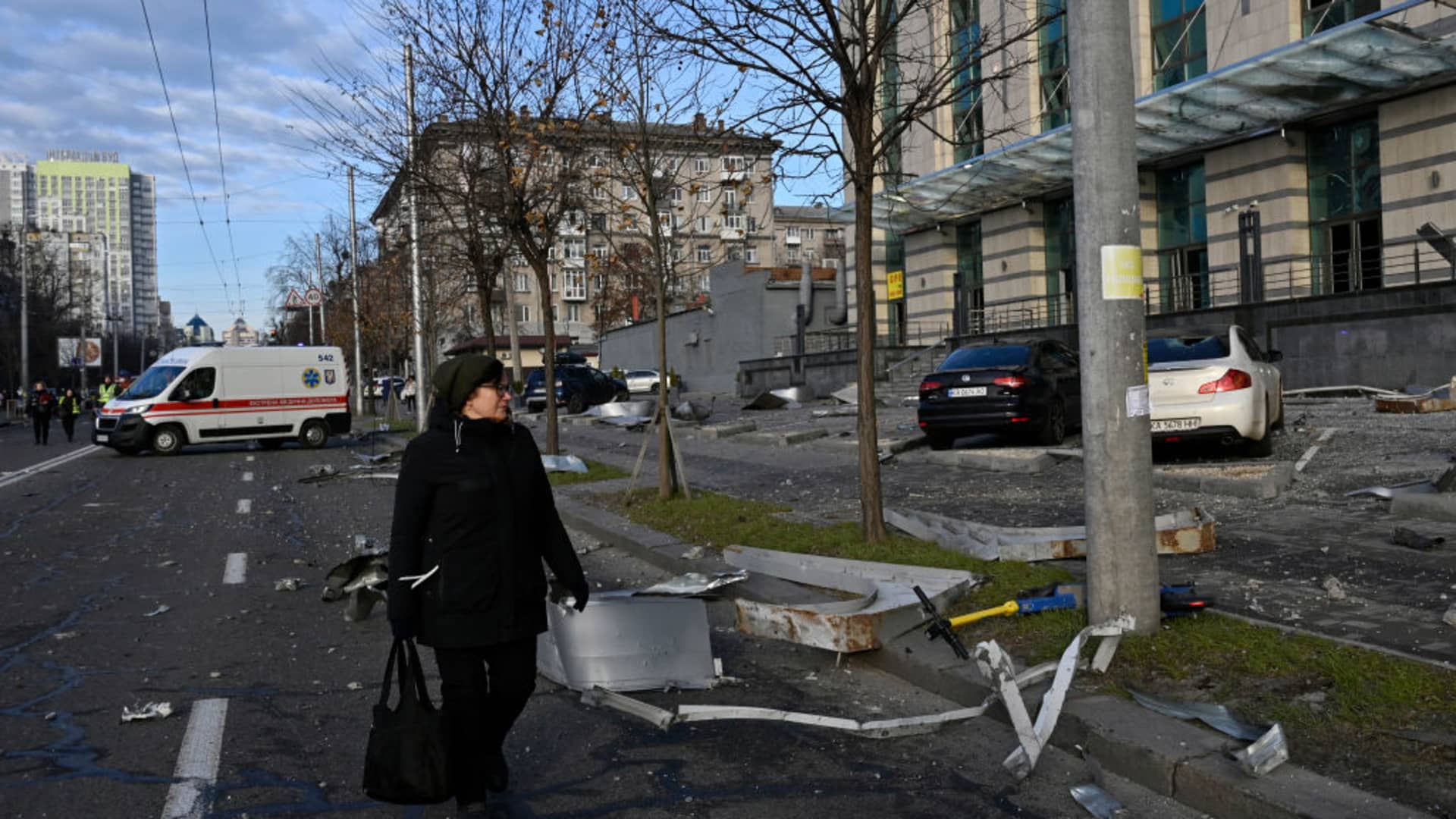 A woman walks past a damaged business centre after a rocket attack in the centre of Kyiv on December 29, 2023, amid the Russian invasion of Ukraine.