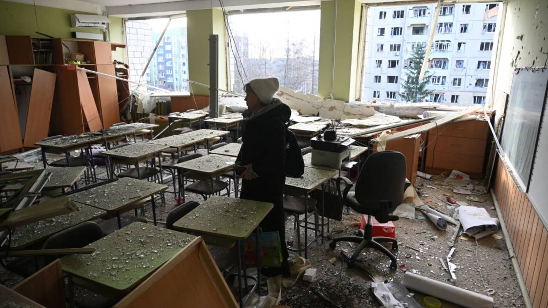 A teacher inspects her classroom that was damaged after a missile attack in Lviv, western Ukraine, on December 29, 2023, amid the Russian invasion of Ukraine. 