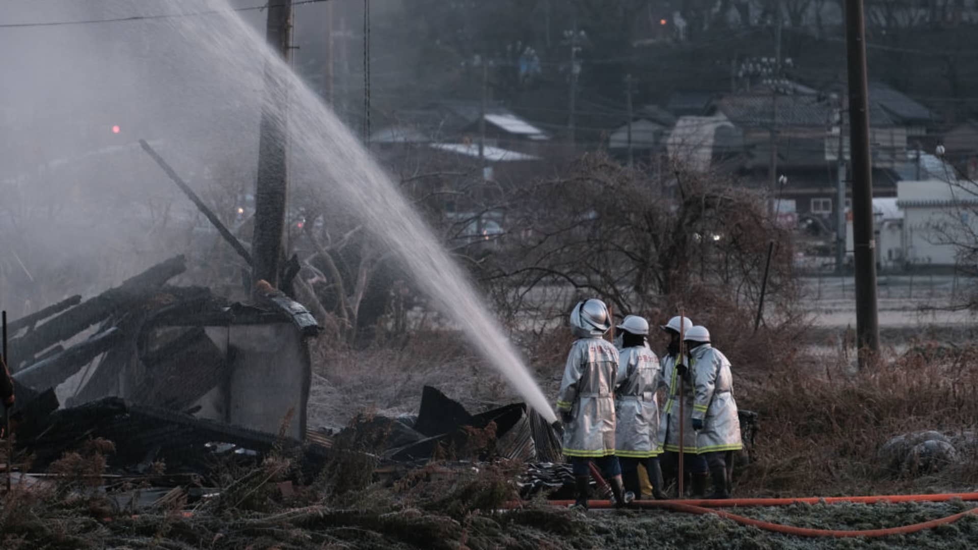 Firefighters extinguish a fire in Nanao, Ishikawa Prefecture, Japan, early on Tuesday, Jan. 2, 2024.