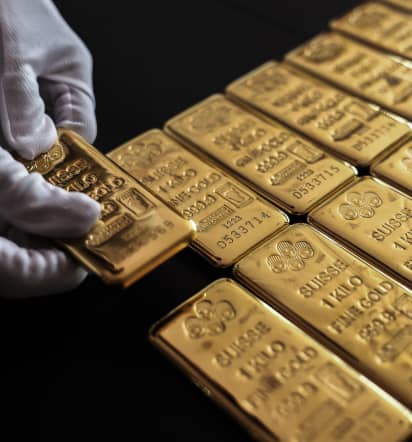 Gold pulls back from record peak as dollar gains