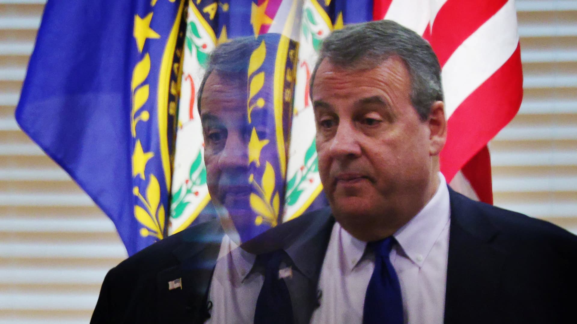 Republican presidential candidate and former New Jersey Governor Chris Christie is reflected in a mirror while speaking at a campaign stop at the RiverWoods Retirement Community in Exeter, New Hampshire, U.S., January 10, 2024. 