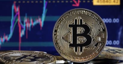Bitcoin rises to record above $69,000, then quickly tumbles 8%