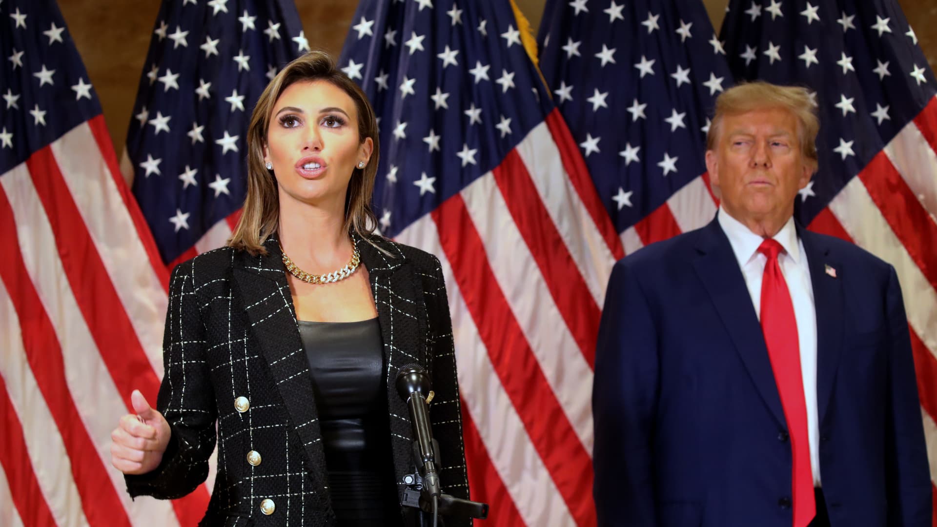 Former U.S. President Donald Trump stands with his lawyer Alina Habba as she speaks to the media at one of his properties, 40 Wall Street, following closing arguments at his civil fraud trial in New York City on Jan. 11, 2024.