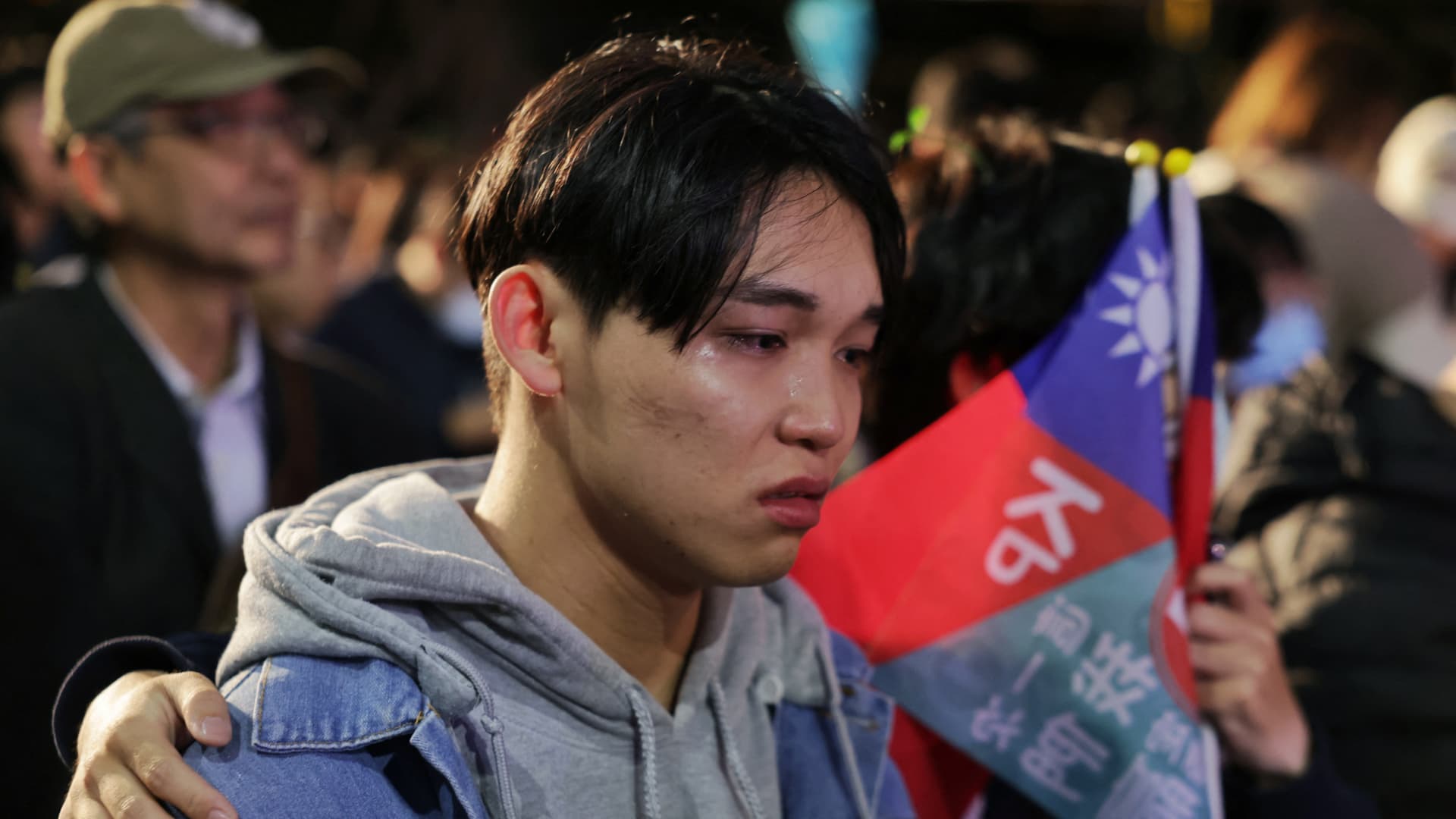 Supporters of Taiwan People's Party (TPP) presidential candidate Ko Wen-je react as they wait for results in the presidential election at the TPP headquarters in Xinzhuang in New Taipei City on January 13, 2024. (Photo by I-Hwa CHENG / AFP) (Photo by I-HWA CHENG/AFP via Getty Images)