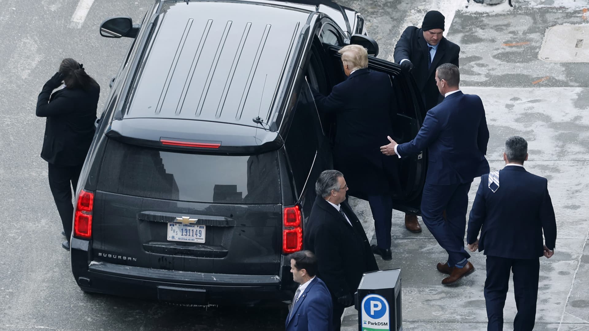 Republican presidential candidate, former U.S. President Donald Trump (C) leaves a meeting with campaign advisors on caucus day, January 15, 2024 in Des Moines, Iowa.