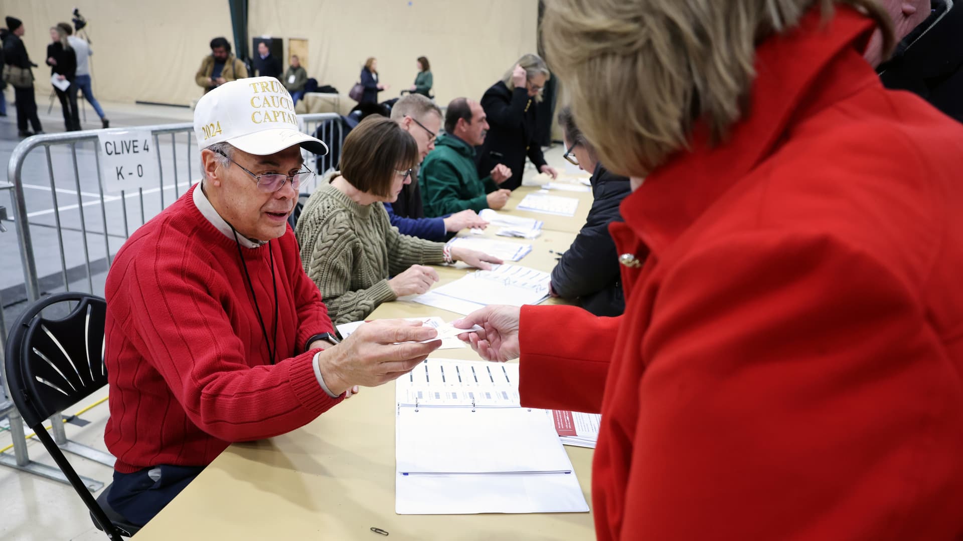A caucus worker checks in voters at a caucus site at the Horizon Events Center on January 15, 2024 in Clive, Iowa.