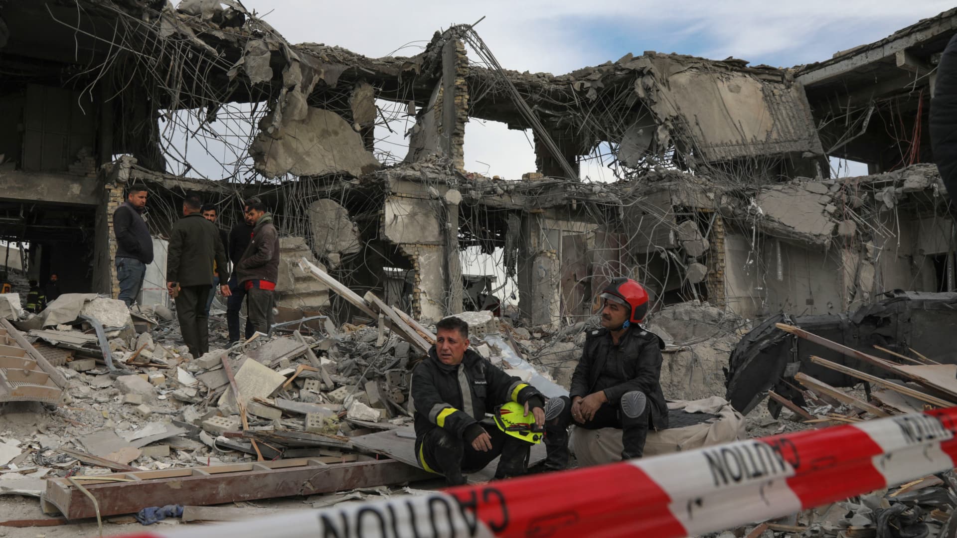 A civil defence team carries out search and rescue operations in a damaged building following a missile strike launched by Iran's Revolutionary Guard Corps (IRGC) on the Kurdistan region's capital of Arbil, on January 17, 2024. 