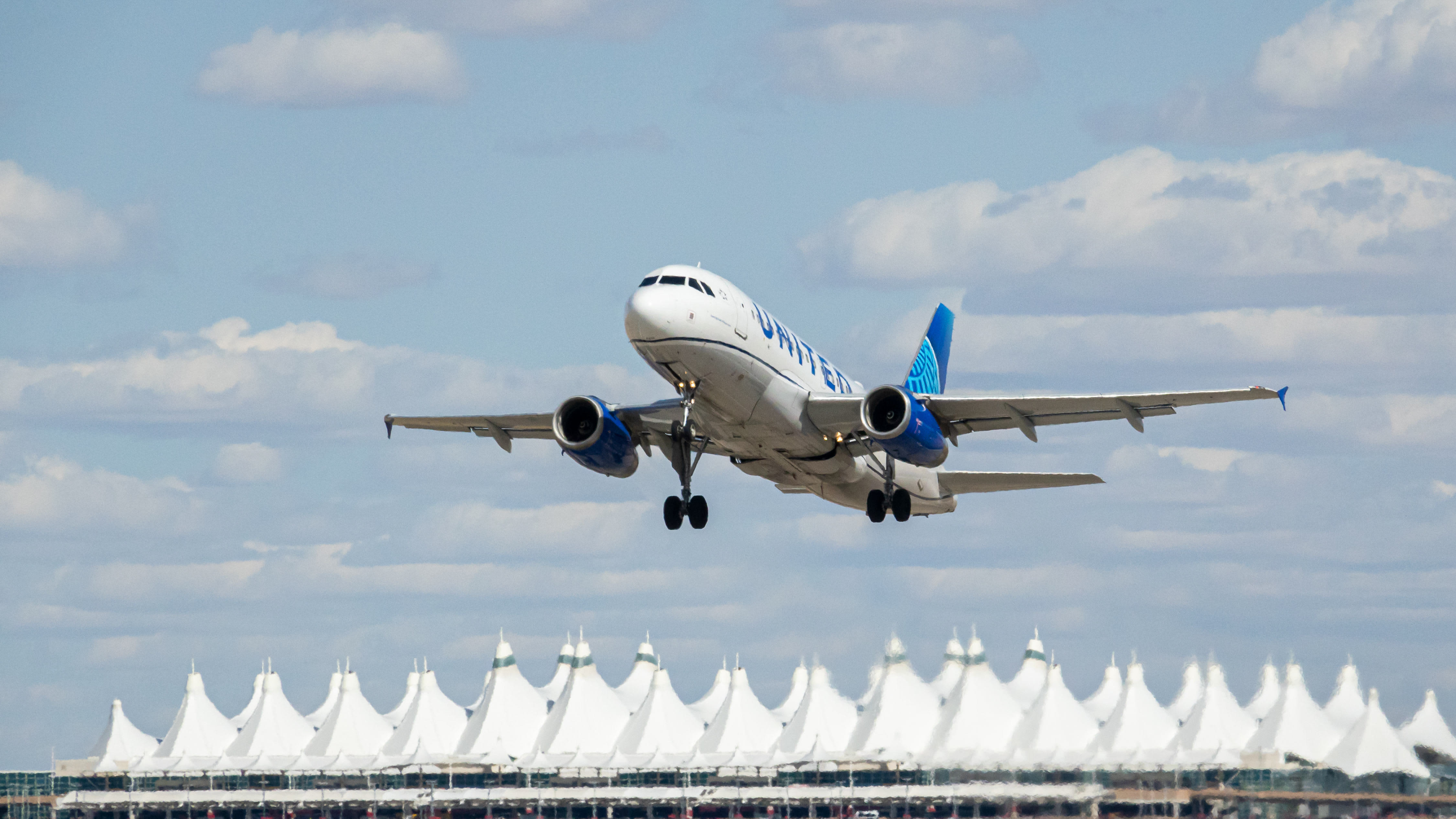 Why did United Airlines invest $1 billion in Denver Airport?
