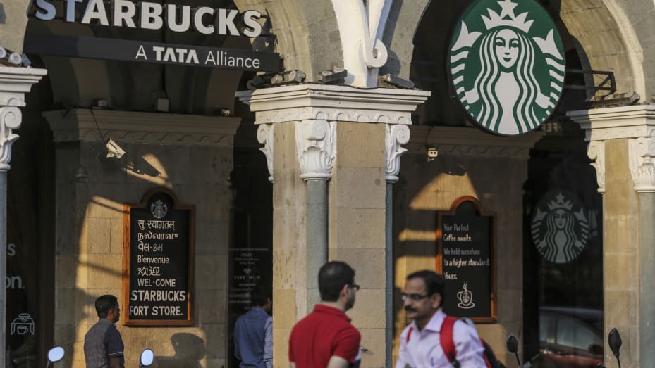Pedestrians walk past a Tata Starbucks coffee shop in Mumbai, India, on Saturday, Nov. 5, 2016.