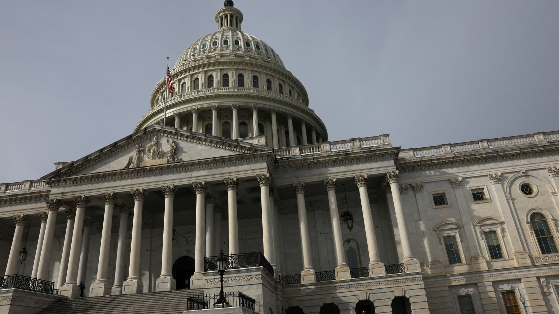 People walk past the U.S. Capitol building as the deadline to avoid partial government shutdown looms in Washington, U.S., January 18, 2024. 