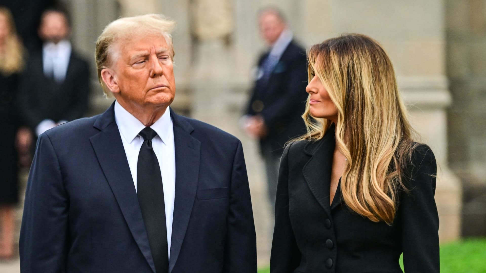 Former U.S. President Donald Trump stands with his wife Melania Trump as they depart the funeral for Amalija Knavs, the former first lady's mother, outside the Church of Bethesda by the Sea, in Palm Beach, Florida, on Jan. 18, 2024.