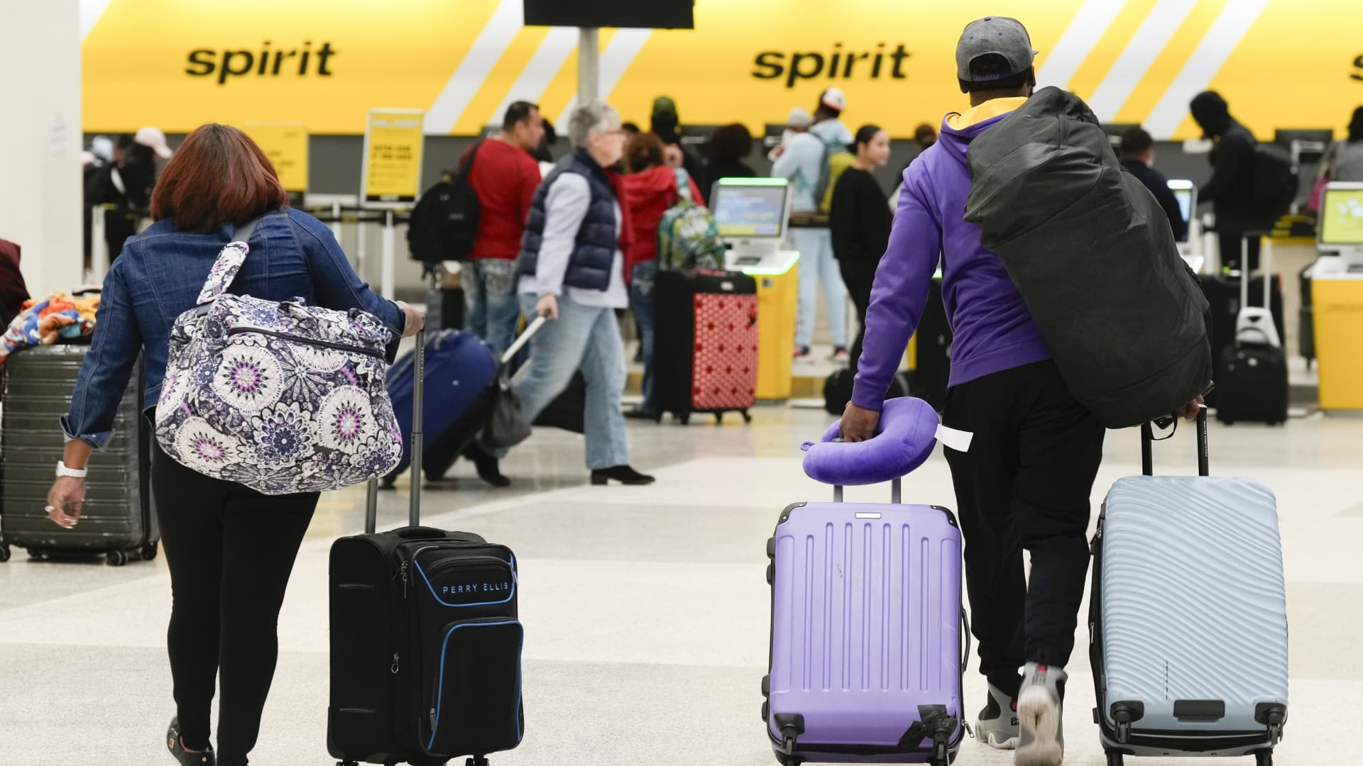 HOUSTON, TEXAS - NOVEMBER 21: Travelers wheel luggage toward Spirit Airlines check-in desk at George Bush Intercontinental Airport, Tuesday, Nov. 21, 2023, in Houston. (Jason Fochtman/Houston Chronicle via Getty Images)