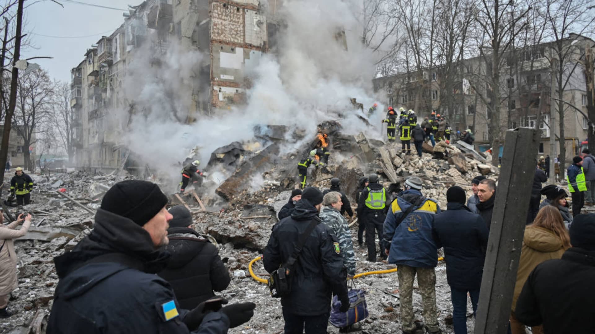 Ukrainian rescue and emergency workers attend the site of a missile attack in Kharkiv on January 23, 2024. Dozens of people were injured and two killed following an overnight aerial barrage by Russian forces targeting the Ukrainian capital Kyiv and the second-largest city Kharkiv, officials said on January 23, 2024. (Photo by SERGEY BOBOK / AFP) (Photo by SERGEY BOBOK/AFP via Getty Images)