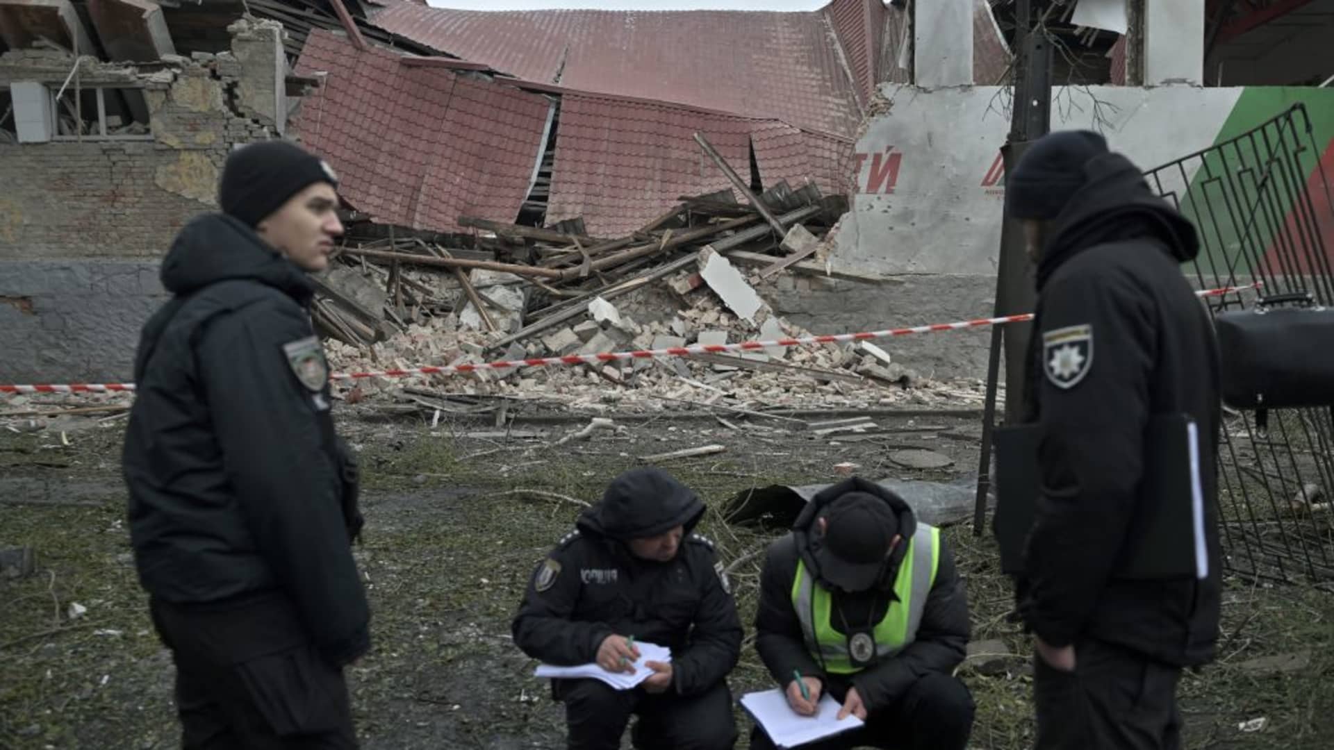 Law enforcement officers work at the site of a missile attack in Kyiv on January 23, 2024. Dozens of people were injured and two killed following strikes on the Ukrainian capital Kyiv and the second-largest city Kharkiv, officials said on January 23, 2024. (Photo by Genya SAVILOV / AFP) (Photo by GENYA SAVILOV/AFP via Getty Images)