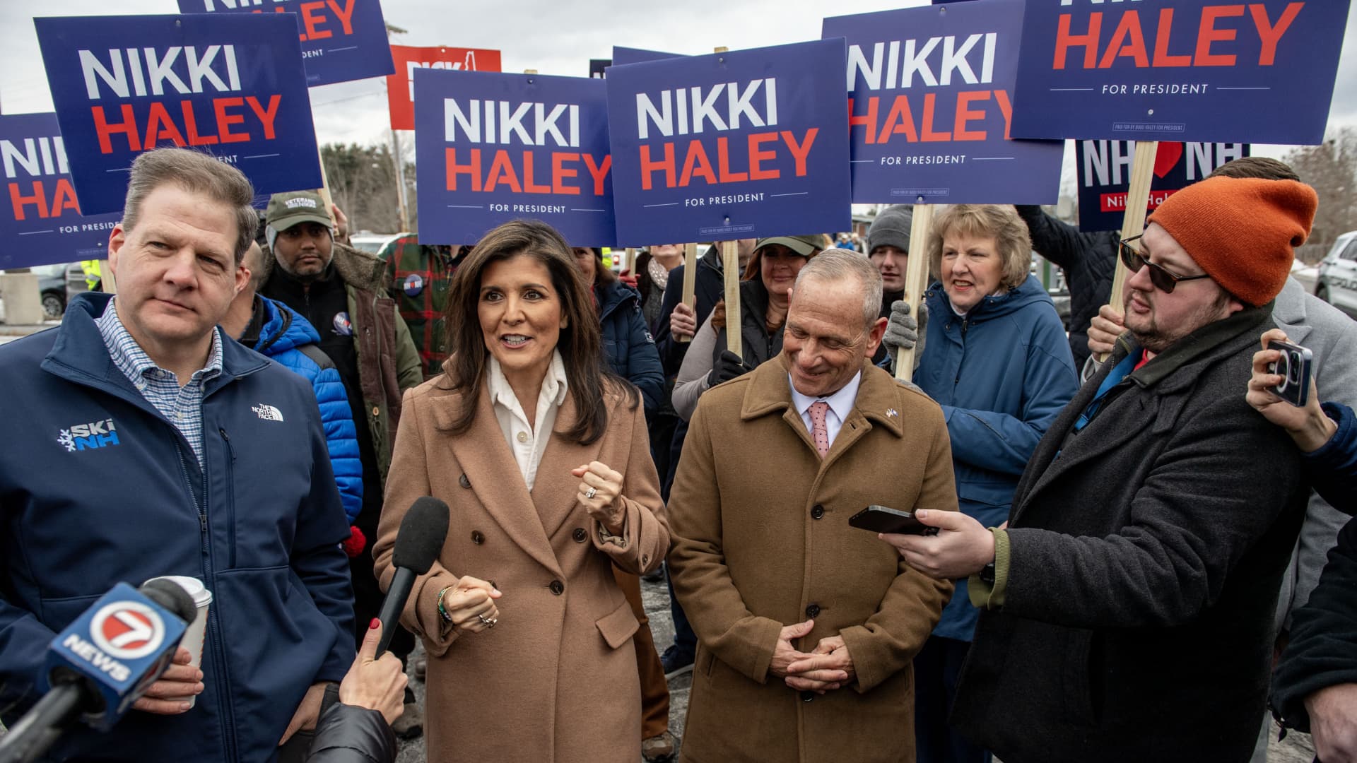 Former UN Ambassador and 2024 presidential hopeful Nikki Haley, with New Hampshire Governor Chris Sununu (L), speaks to the press outside a polling site at Winnacunnet High School in Hampton, New Hampshire, on January 23, 2024.