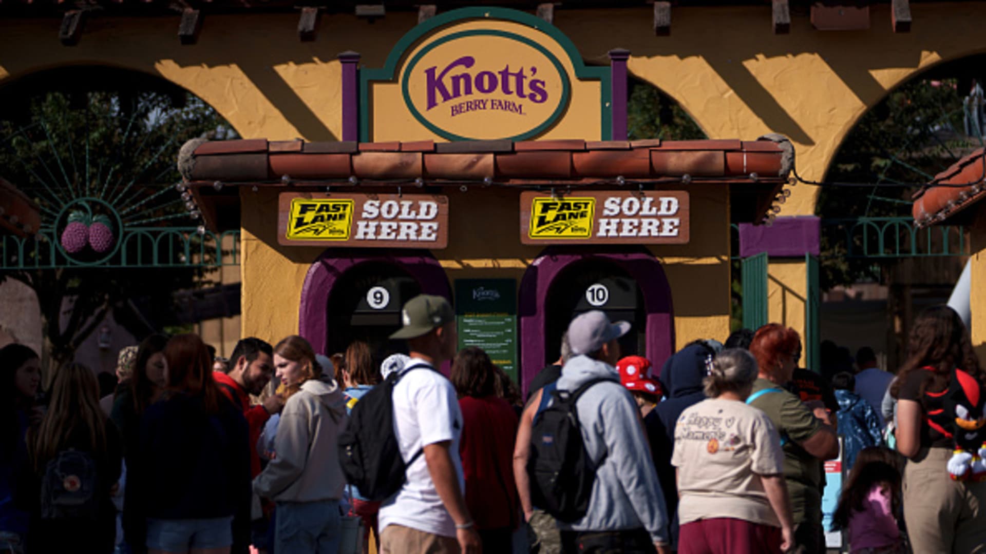 Guests wait in line to buy tickets to Knott's Berry Farm theme park, owned and operated by Cedar Fair Entertainment Co., in Buena Park, California, US, on Saturday, Nov. 4, 2023. Cedar Fair Entertainment Co. is acquiring rival Six Flags Entertainment Corp. for about $1.88 billion in a deal that will create one of the biggest theme-park operators in the Americas. Photographer: Eric Thayer/Bloomberg via Getty Images