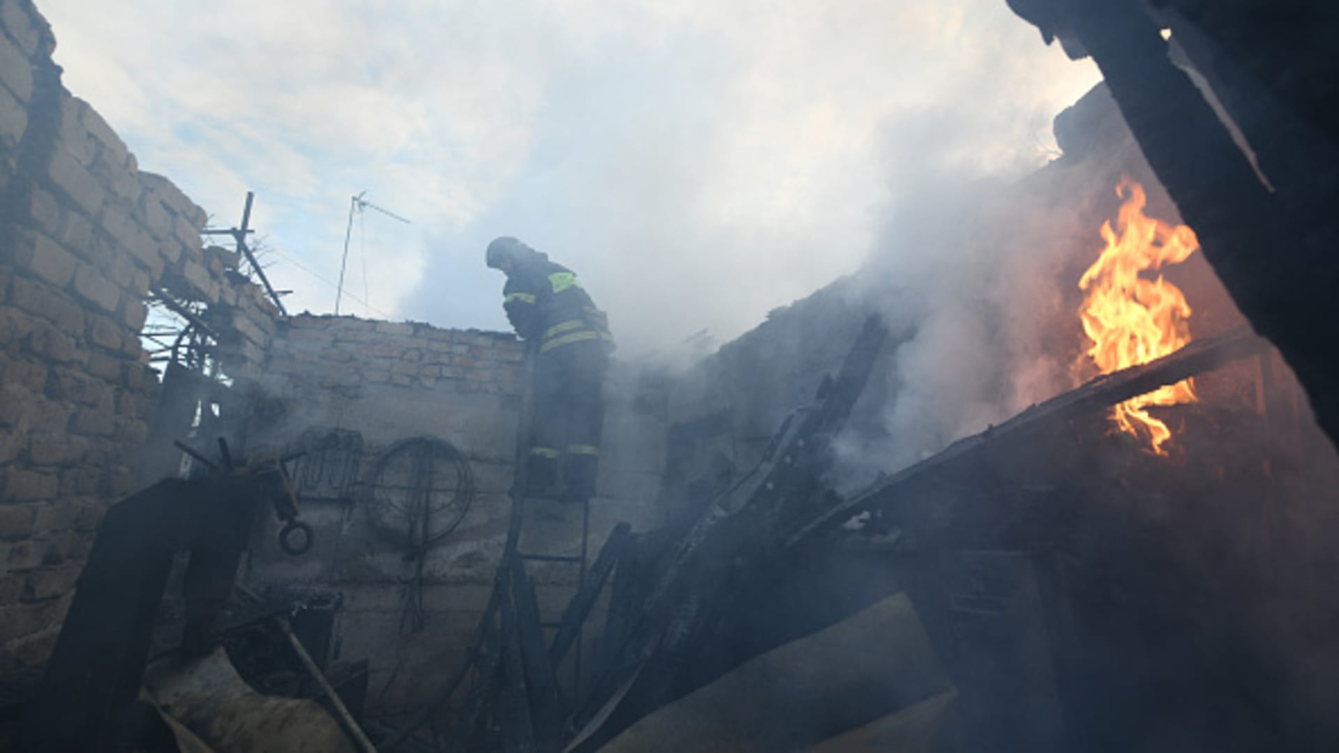 Firefighters work in a destroyed building hit by recent shelling in a residential area in Donetsk, Russian-controlled Ukraine, on January 29, 2024, amid the Russia-Ukraine conflict. 