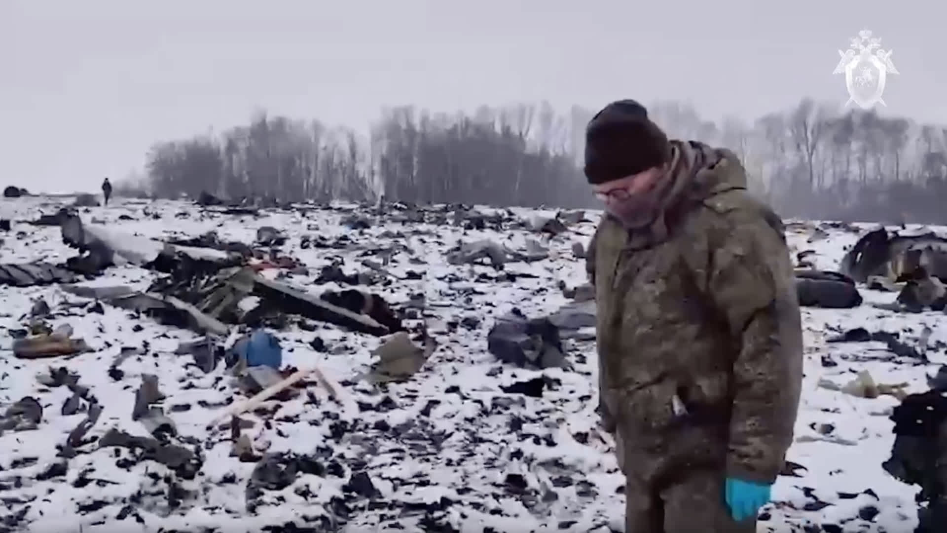 A screen grab captured from a video shows officials inspect the site after Russian IL-76 military transport plane crashed in the Belgorod region in Russia near the border with Ukraine on January 25, 2024. 