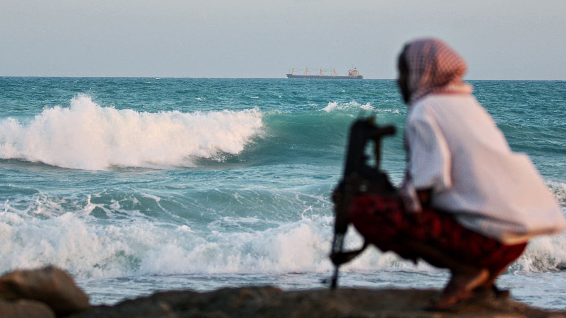 A 2010 photo of an armed Somali pirate keeping vigil on the coastline at Hobyo, northeastern Somalia, while the Greek cargo ship, MV Filitsa is anchored just off the shores of Hobyo where it was held by pirates after beimng captured some 513 nautical miles northeast of the Seychelles as it was sailing from Kuwait to Durban in South Africa loaded with fertilizer. 