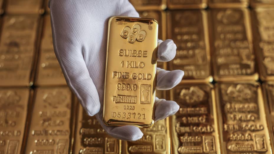 An employee holds one kilogram gold bullion at the YLG Bullion International Co. headquarters in Bangkok, Thailand, on Friday, Dec. 22, 2023.