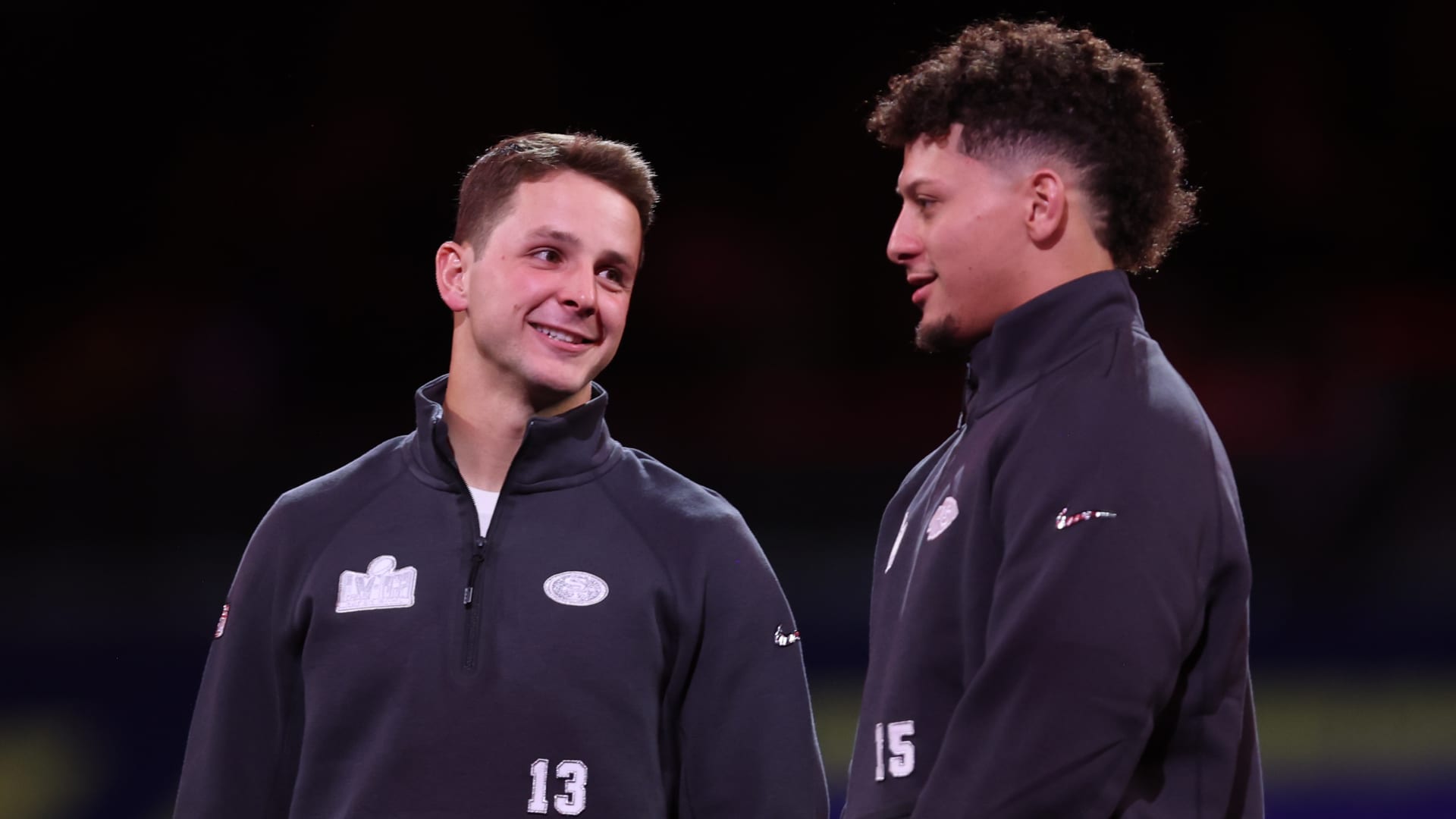 Brock Purdy #13 of the San Francisco 49ers and Kansas City Chiefs quarterback Patrick Mahomes (15) stand on stage during Super Bowl LVIII Opening Night at Allegiant Stadium on February 5, 2024 in Las Vegas, NV. 