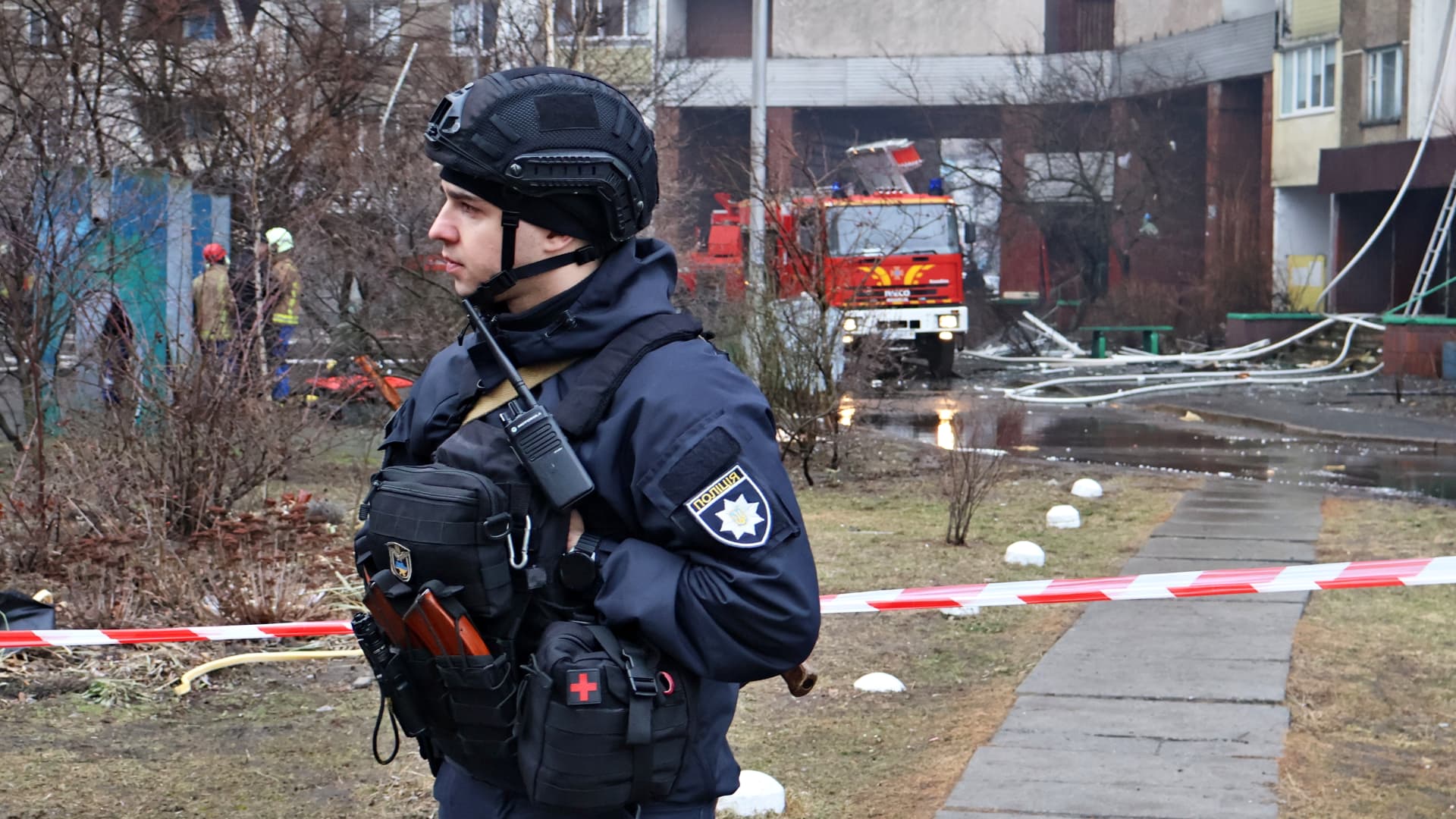 Emergency services stand near the site of a missile attack in a residential area of the city in Kyiv. Russia launched a missile strike on Kyiv, Ukraine, according to the statement from local authorities, more than 20 rockets were shot down. 