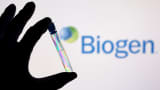 A test tube is seen in front of displayed Biogen logo in this illustration taken on, December 1, 2021.