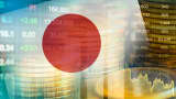 An editorial picture of the Japan flag set against an economic trend graph and images associated with the stock market, finance and digital technology.