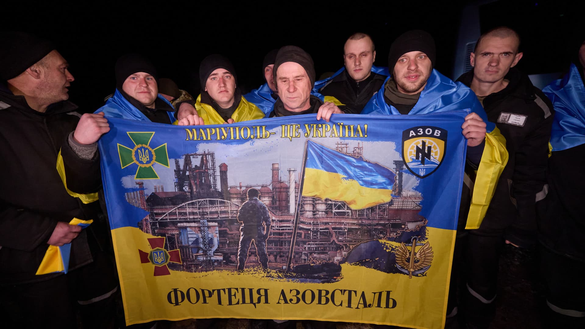 Released Ukrainian servicemen who return to home with bus, pose for a photo with Ukrainian flags in front of the bus as Russia and Ukraine exchanged 100 prisoners of war from each side Thursday through mediation by the United Arab Emirates (UAE), according to the Russian Defense Ministry in Kyiv, Ukraine on February 08, 2024. 