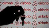 A key is seen in front of a computer screen displaying the Airbnb logo in Ankara, Turkey, on Nov. 22, 2023.
